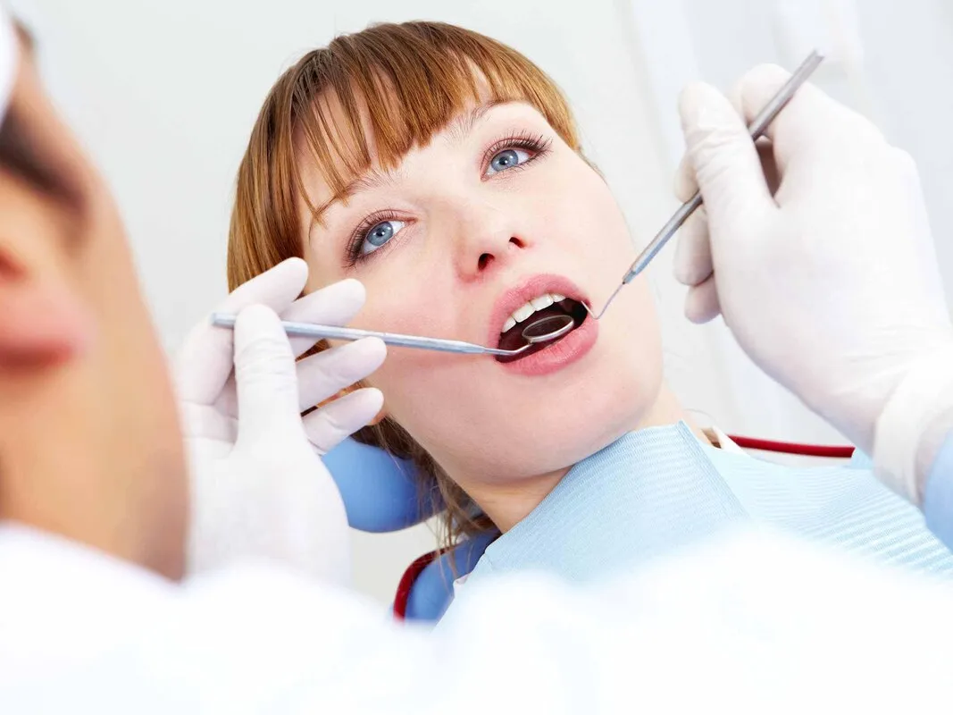 Dentalhygienikerin bei der Behandlung einer Patientin